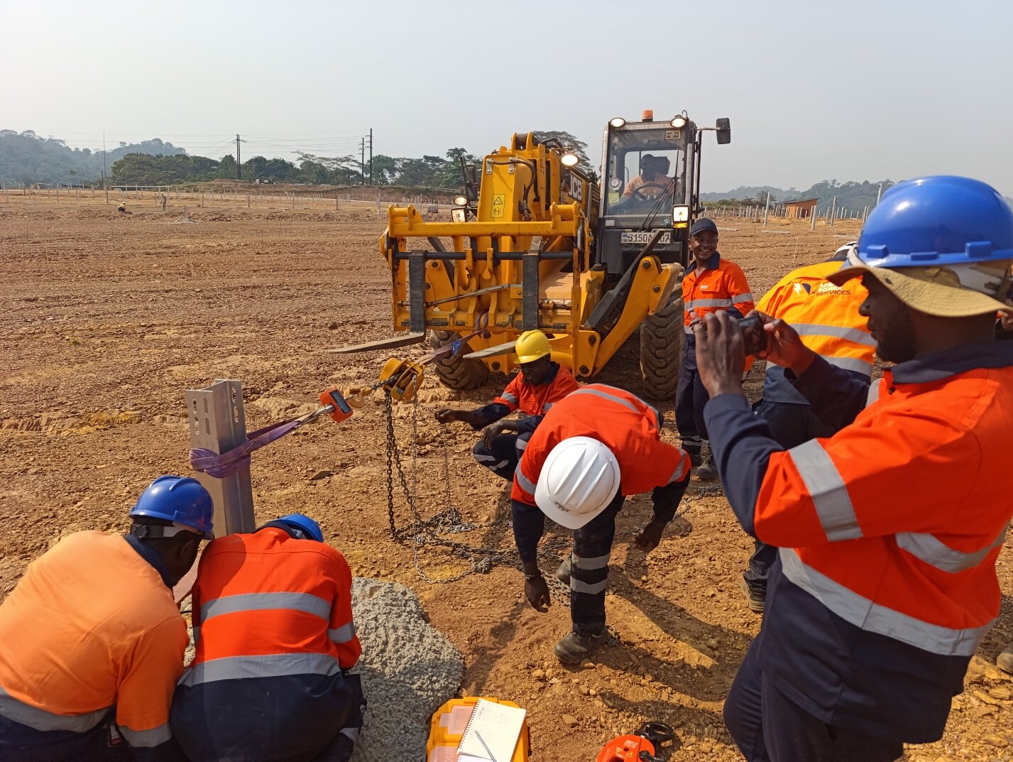 Field technicians carrying out solar PV pile testing in Africa
